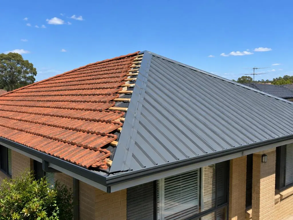 Tile to metal roof conversion in progress on a brick home